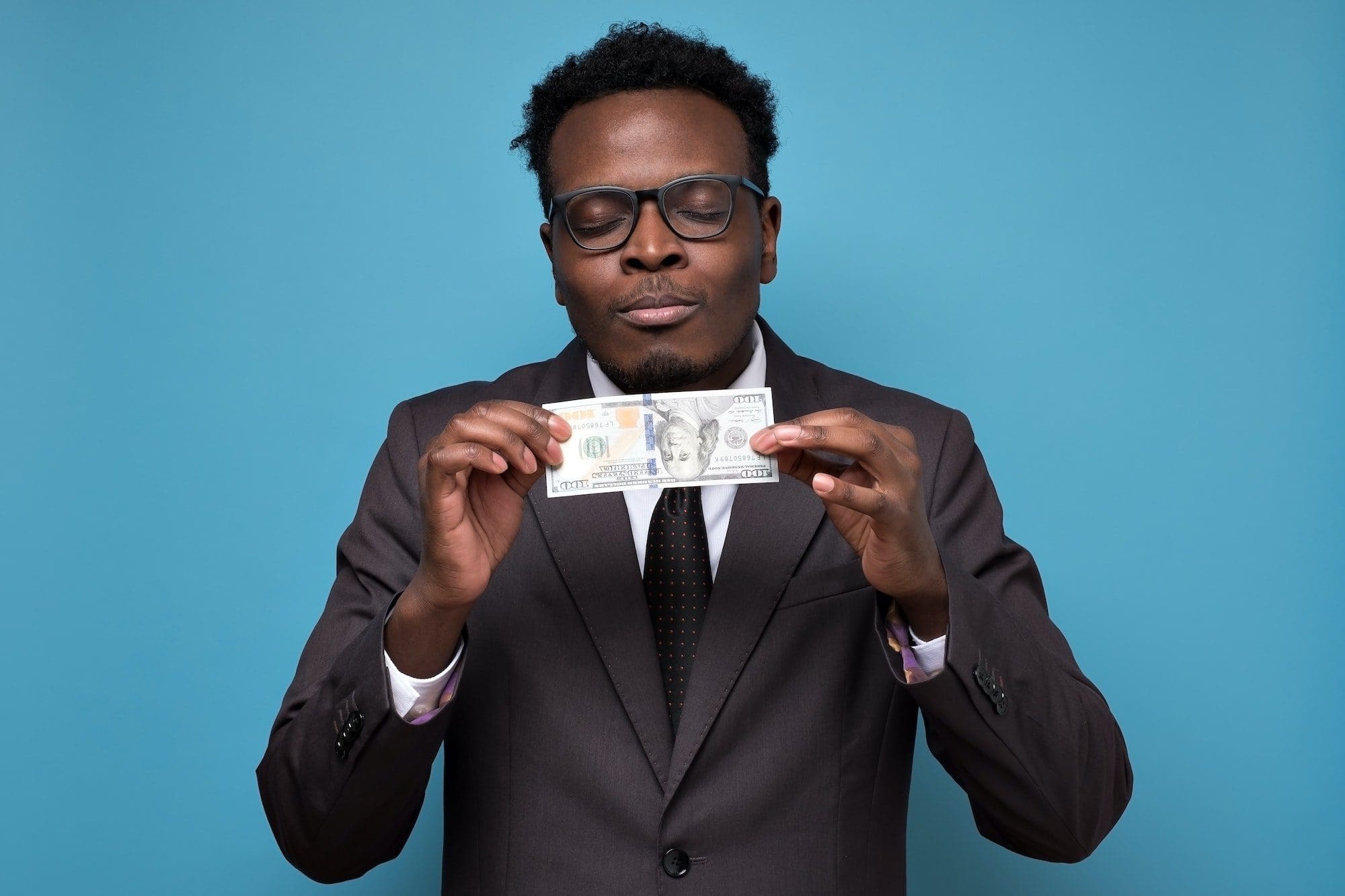 Successful young african businessman showing you money