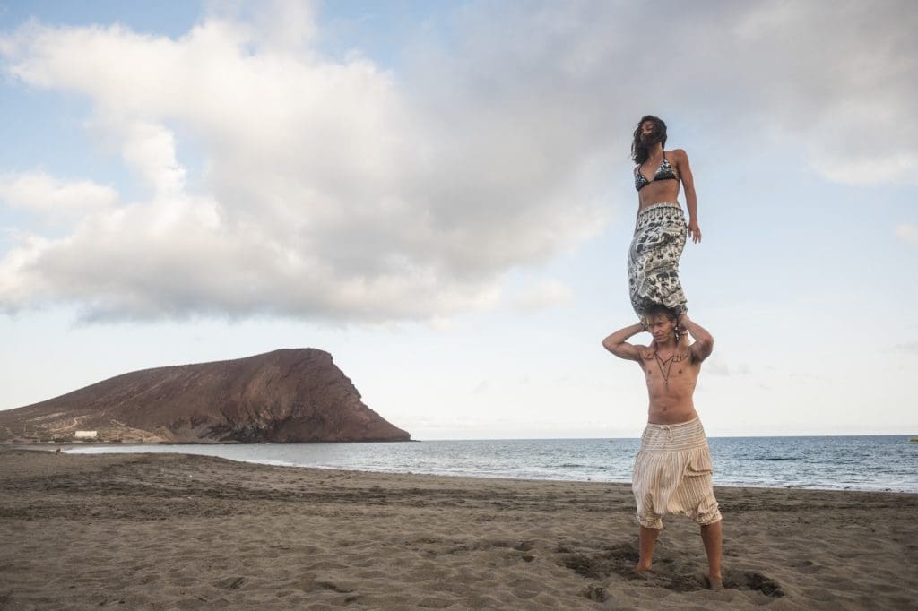 acrobatic balnced position for beautiful brave couple man and woman at the beach